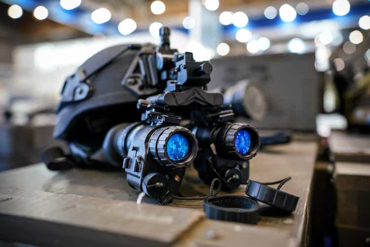 Military helmet night vision goggles, close-up detail with blue reflective lenses