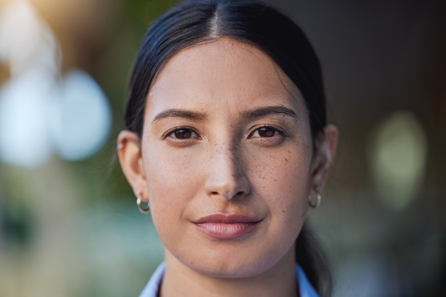 Closeup portrait of mixed race woman"s face and eyes looking forward and into the camera. Zoom headshot of a hispanic woman staring and watching in front. Healthy eyecare for clear optics and vision