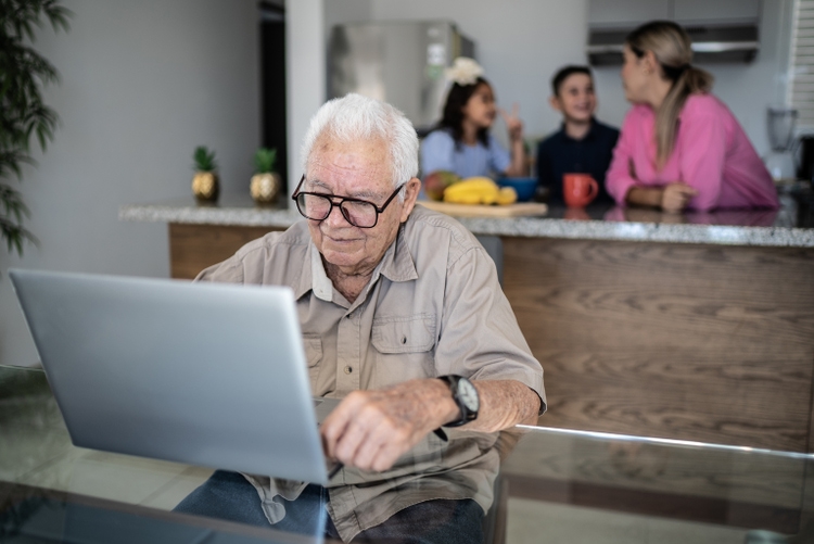 Senior man using laptop at home