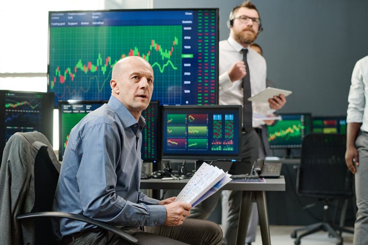 Co-workers Checking Trading Charts