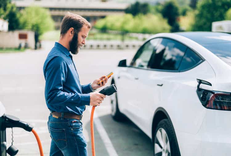 Man charging electric car