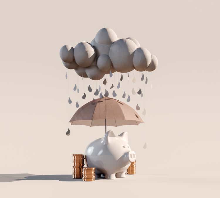 Piggy bank with stacked coins and umbrella under the rainy cloud