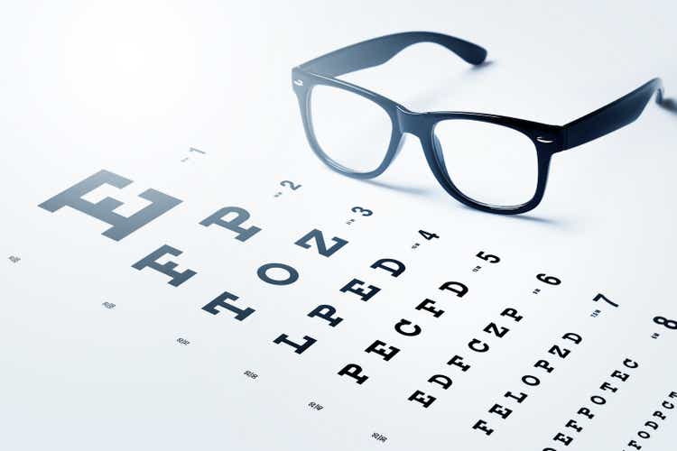 Eye chart for visual acuity testing and black rimmed eyeglasses
