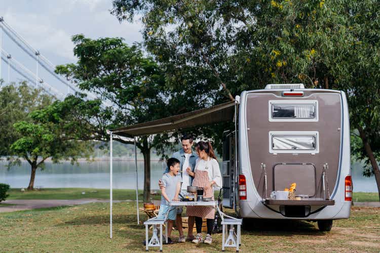Asian family caravan picnic vacation at public park
