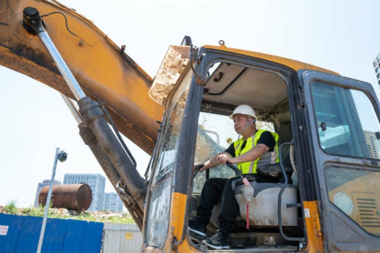 Construction machinery male driver at work