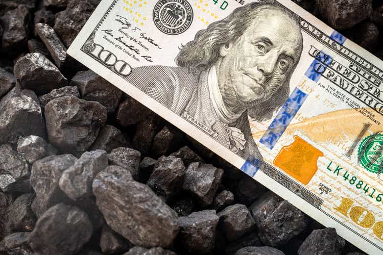 American money sticking out of a pile of coal, 100 dollar banknote, US mining concept, Rising coal prices, Environmental impact, National economy