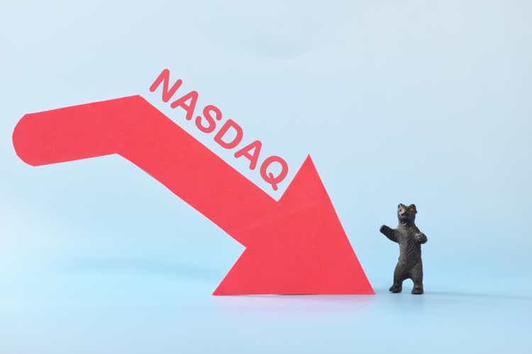NASDAQ index in red downward arrow with decreasing stack of coins. Bearish run market in United States US stock market.