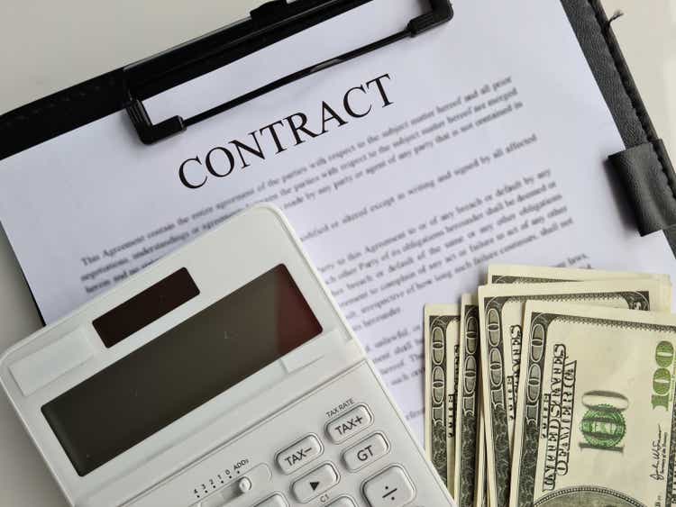 Contract agreement calculator and business financial profit closeup
