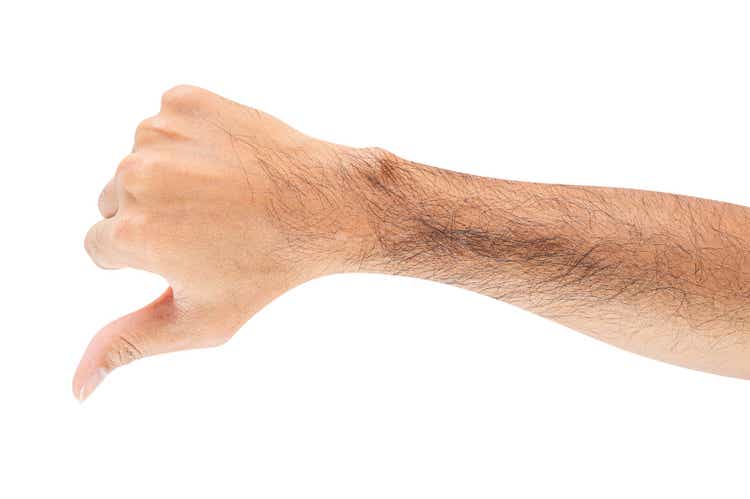 Male hand showing thumbs down sign isolated on white background.