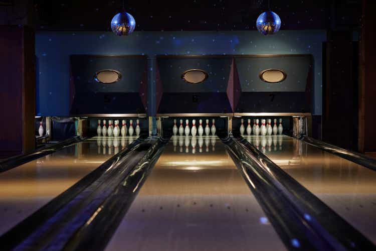 Bowling pins lined up on a track at a bowling alley