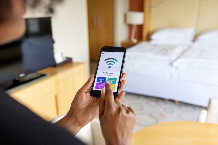 Close-up of a businesswoman connecting to the mobile wifi in hotel room