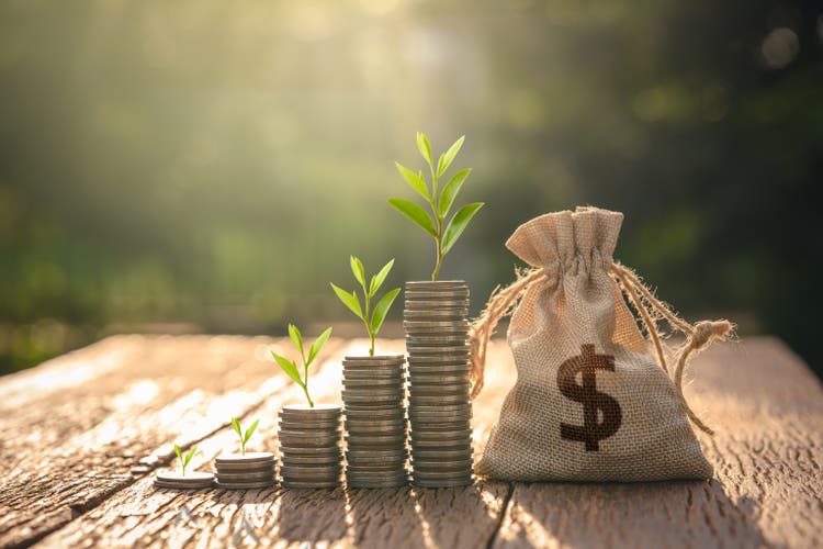 stacking money coin and Money bag and with grow up. for loans to planned investment in the future concept.