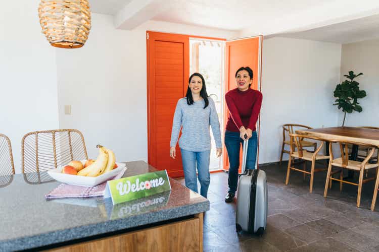 Lesbian couple arrive at vacation rental