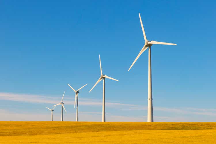 A row of wind turbines in sunny rural France - clean renewable energy