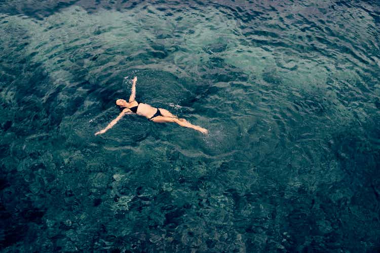 Female Enjoying A Relaxing Sea Swim In Ibiza