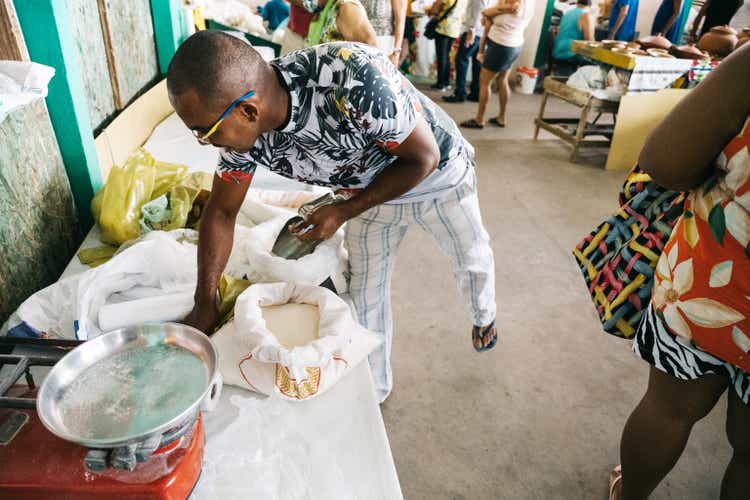 market vendor at his stall with cassava flour in Brazil