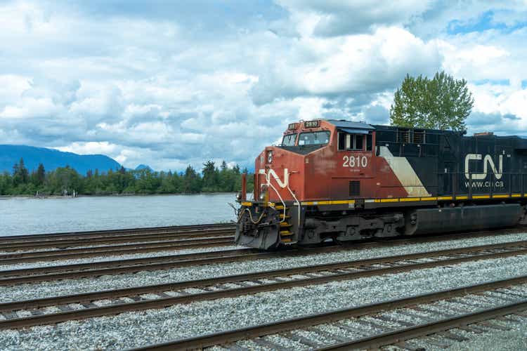 Canadian National Railway freight train traveling on rural area.