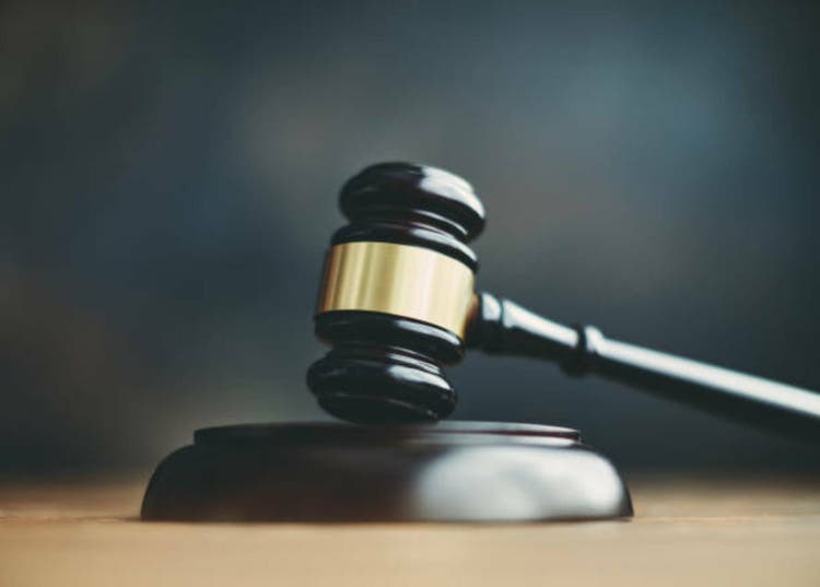 Gavel on block on a desk or table with space for copy