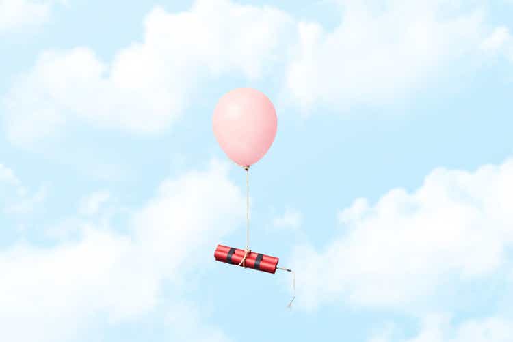 Bundle of dynamite sticks tied to a balloon in the sky