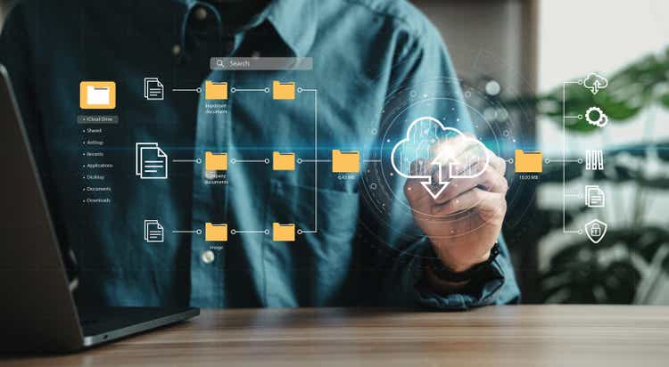 Man using laptop showing cloud computing diagrams digital technology information exchange and future technology ideas Data Document Management System (&lt;a href='https://seekingalpha.com/symbol/DMS' title='Digital Media Solutions, Inc.'&gt;DMS&lt;/a&gt;) Network and Internet Service Concepts