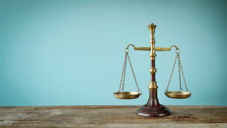 Scales of justice on the wooden table