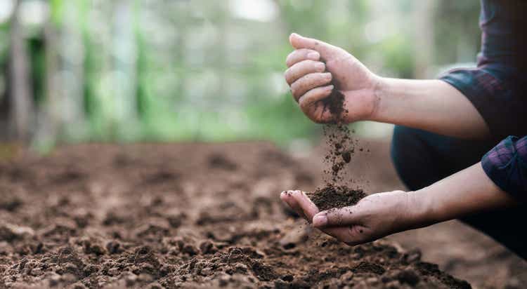 Farmer holding soil in hands close-up. Farmers" experts check soil conditions before planting seeds or seedlings. Business idea or ecology environmental concept