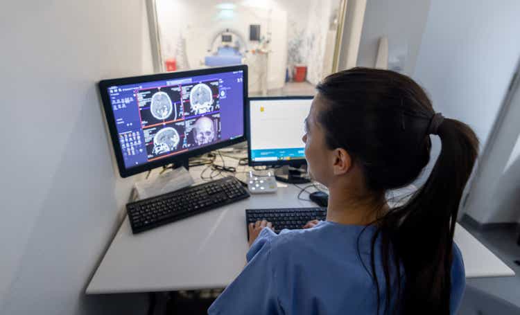 Radiologist in the control room performing an MRI scan