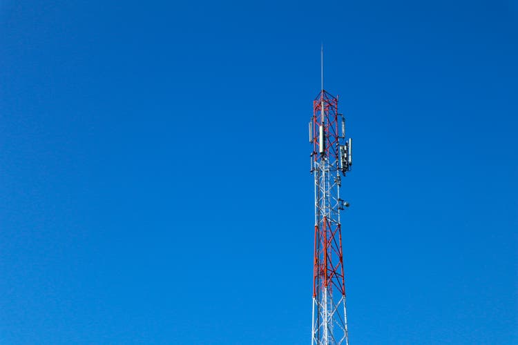 " communication tower. Telco Trellis for 3G 4G 5G Apocalypse Internet Communication, mobile, FM Radio and Television Broadcasting On Air with Blue Sky in Background"