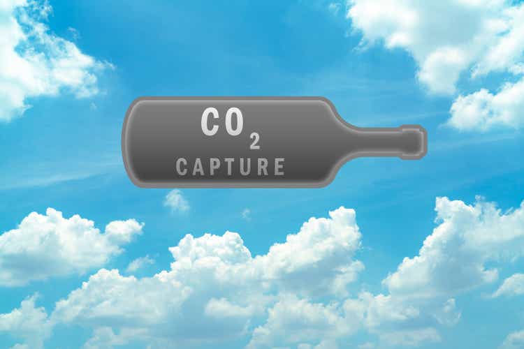 CO2 capture in gray bottle on blue sky and white cumulus clouds. Carbon capture and storage technology concept. Greenhouse gas. Carbon dioxide gas global air climate pollution. Environment issue.