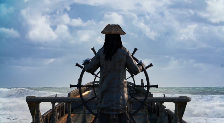 the pirate captain holds the ship"s steering wheel and sails across the sea on a sailing pirate ship render 3d