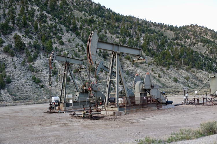 Mountain landscape with oil pumping equipment