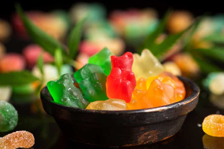 Colored candy gelatin in a black bowl with marijuana leaves