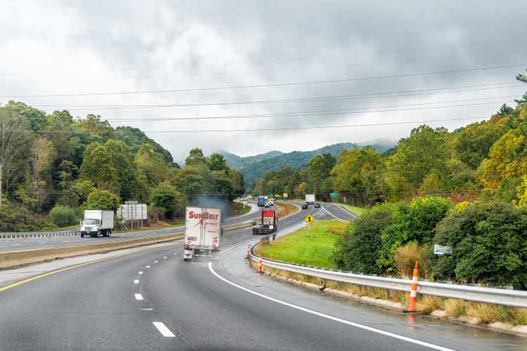 Truck blowing smoke pollution on Interstate highway i40 in North Carolina near Asheville with sign for Ridgecrest