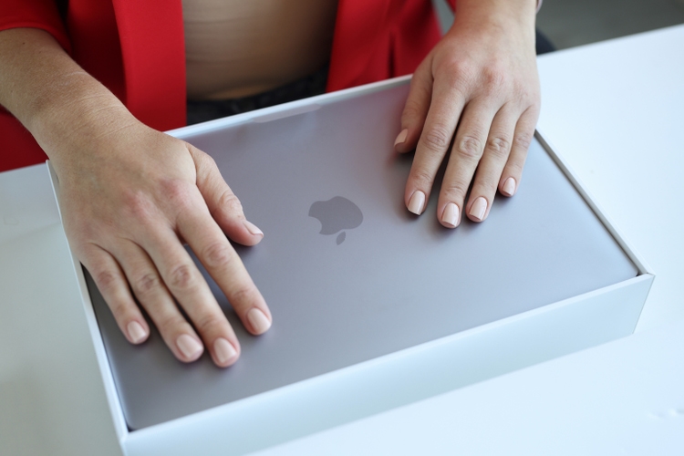 Minsk, Belarus, April 1, 2022: Female hands on new MacBook Air closeup