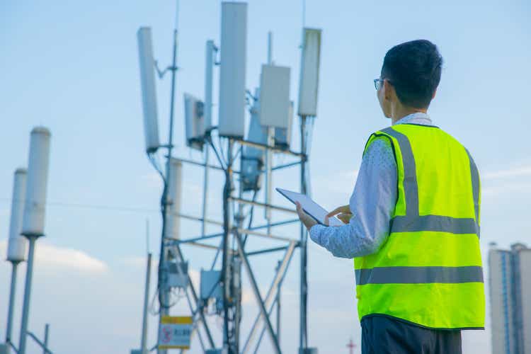 Engineer hand using digital tablet testing the communications tower