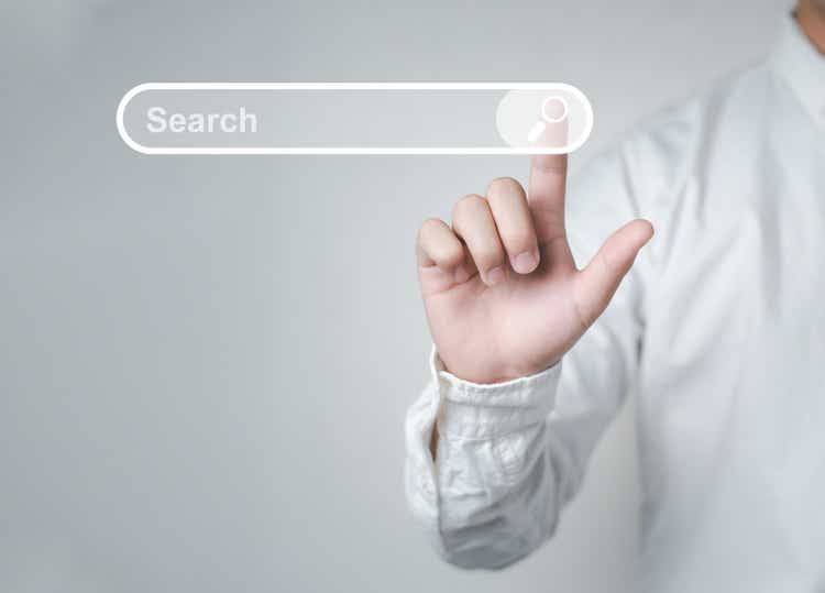 Man standing with hands pointing to information search is a data clicking to virtual internet search page computer touch screen