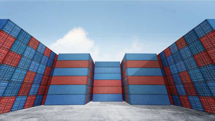 Stack of cargo containers box in port shipping yard background, Containers with blue sky and floor ground, Copy space, logistics import export goods of freight carrier transportation industry concept