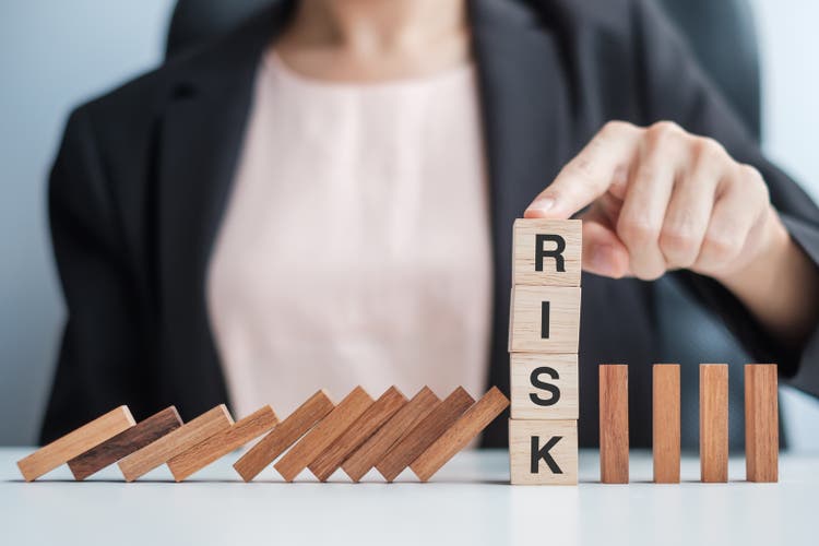 Businesswoman hand Stopping Falling wooden Blocks or Dominoes. Business, Risk Management, Solution, Insurance and strategy Concepts