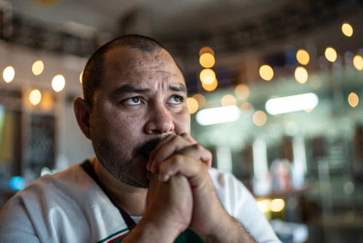 Mid adult man watching a soccer game at bar