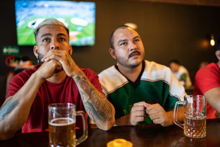 Friends watching sports at bar