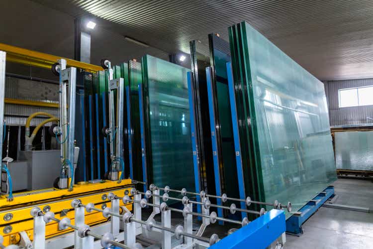 Factory for the production of double-glazed windows made of sheet glass. Sheet glass in pallets near the sheet glass cutting line.