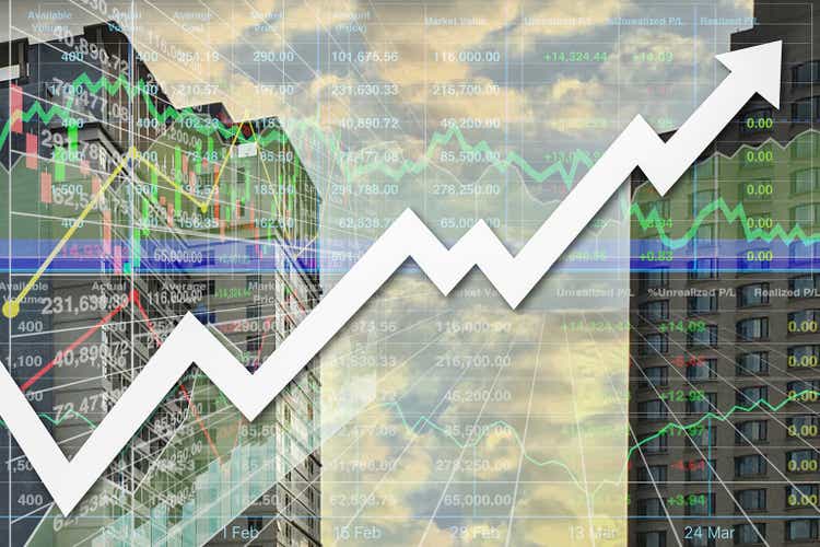 Stock financial index data diagram with arrow up, graph, chart, candlesticks and number show successful investment on property business and real estate industry with twilight silhouette building background.