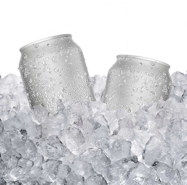 Cans with water droplets and ice on ice cubes Isolated on white background