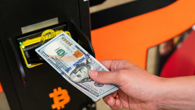 Atm bitcoin cryptocurrency machine. Woman withdraw american dollar bill cash. Usd hundred money payment on virtual crypto currency btc wallet. Bitcoin BTC ATM Cash Machine.