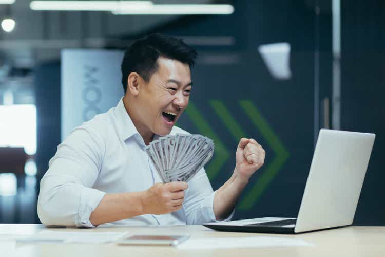Successful Asian investor businessman, happy with victory and conclusion of investment contract
