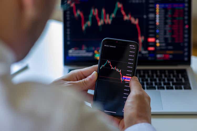 Businessman analyzing crypto currency market graphs