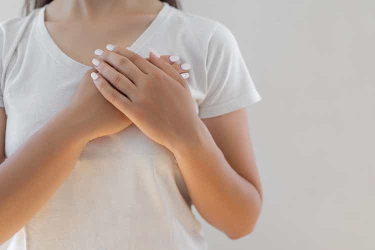 Woman hands checking her breast