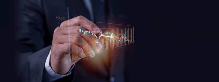 Businessman pointing arrow graph growth and financial network connection, analyzing report data to increase sales and revenue profit to achieve business investment goal in global economic situation.