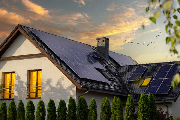 Solar photovoltaic panels on a house roof. Sunset.