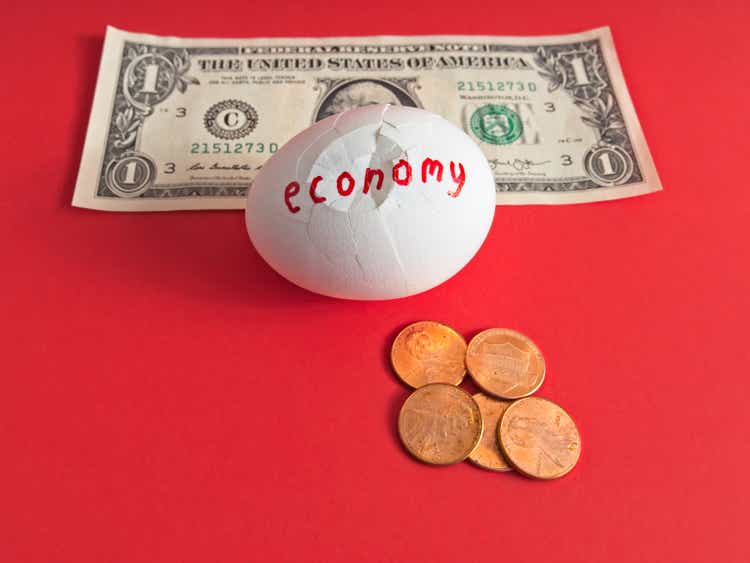 The fractured economy represented by a cracked egg depicting the decline in buying power of dollar to pennies